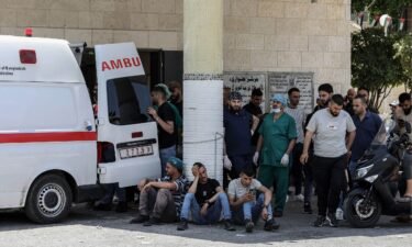 Palestinians wait outside a hospital while paramedics transport injured people during a large-scale Israeli military operation in the West Bank town of Jenin. At least eight Palestinians were killed
