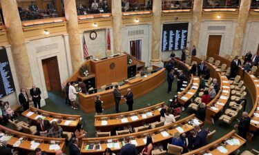 Arkansas lawmakers gather in the House of Representatives chamber at the state Capitol in Little Rock