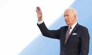 U.S. President Joe Biden waves upon arrival in Helsinki