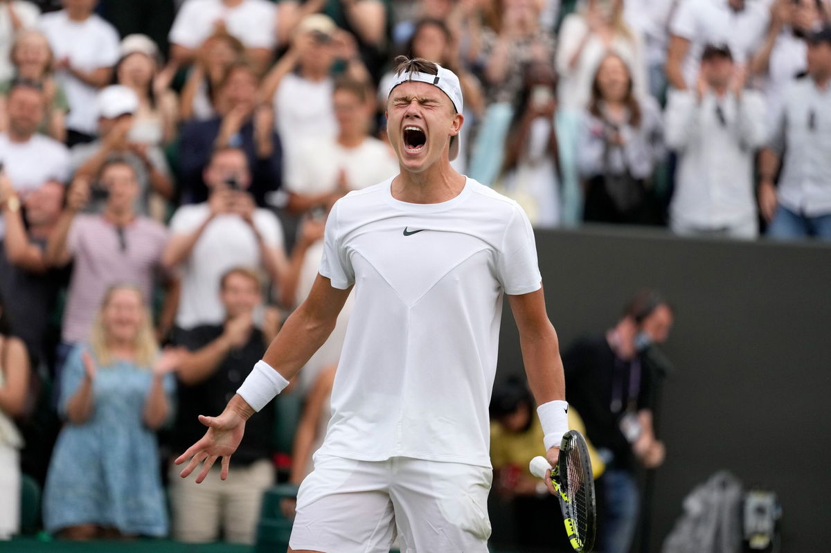 <i>Kirsty Wigglesworth/AP</i><br/>Denmark's Holger Rune celebrates after beating Spain's Alejandro Davidovich Fokina.