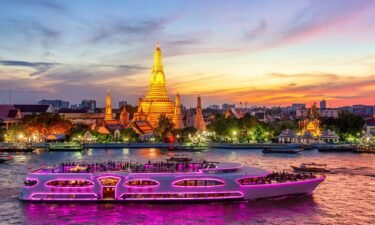 A boat glides past Wat Arun in Bangkok