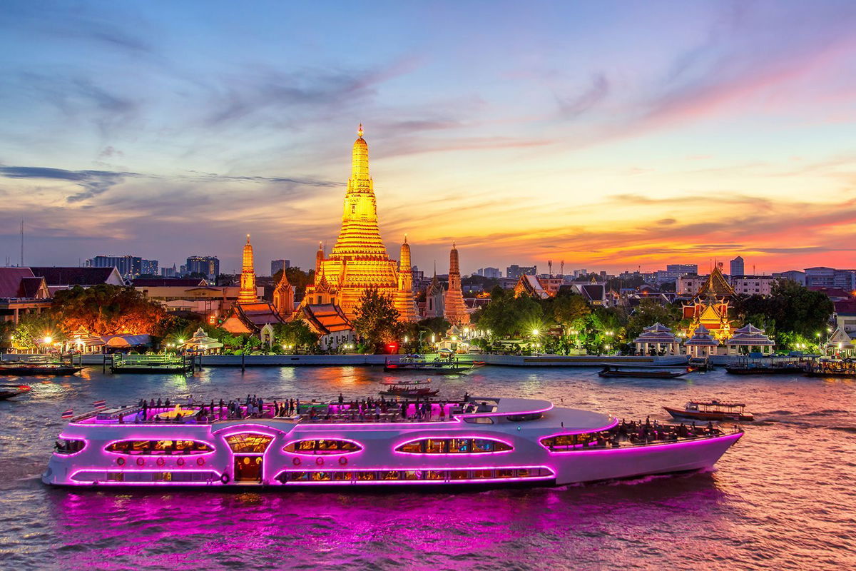 <i>Pakin Songmor/Moment RF/Getty Images</i><br/>A boat glides past Wat Arun in Bangkok