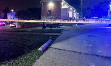 Baltimore police investigate the scene where a shooting occurred during a block party early this morning.