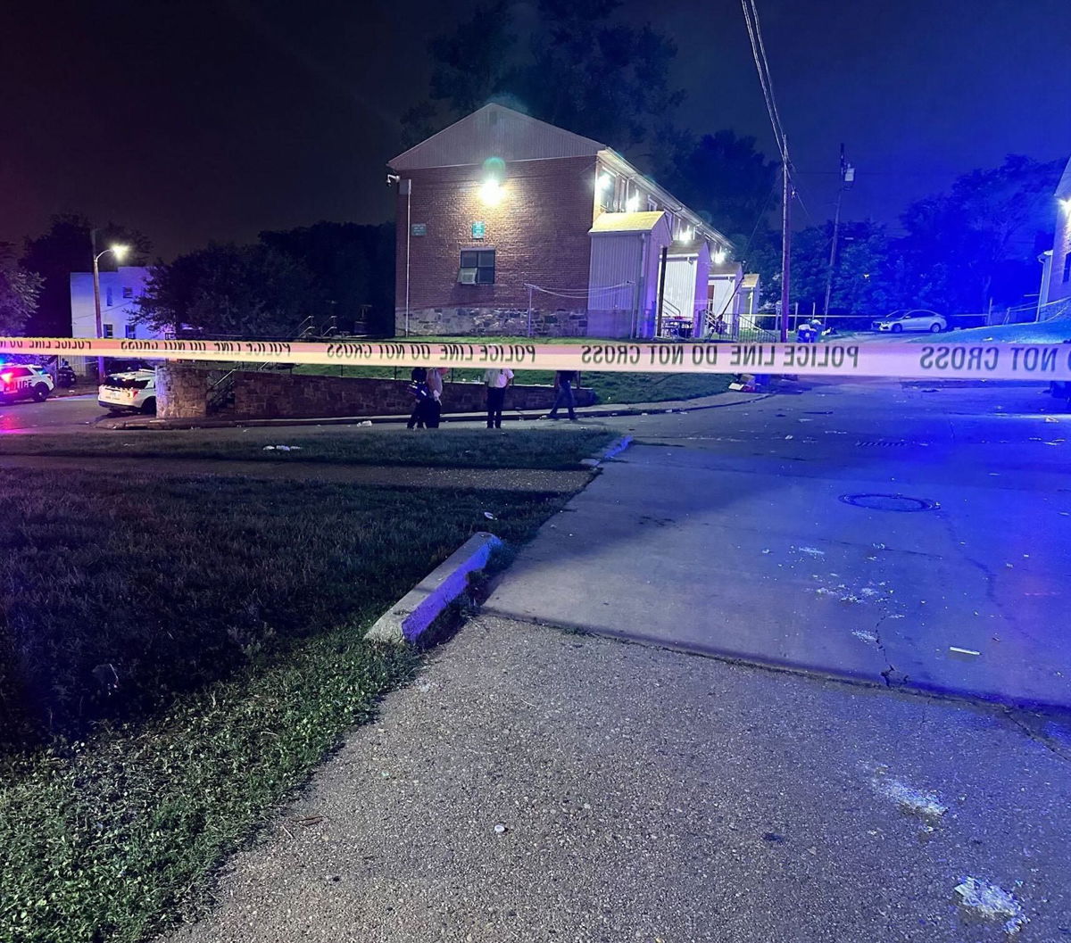 <i>Baltimore Police</i><br/>Baltimore police investigate the scene where a shooting occurred during a block party early this morning.
