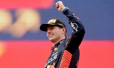 Red Bull's Max Verstappen celebrates on the podium after winning the race.