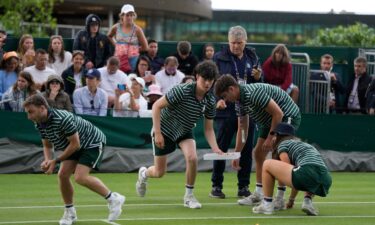 Ground staff removed pieces of confetti from Court 18 before play got back underway.