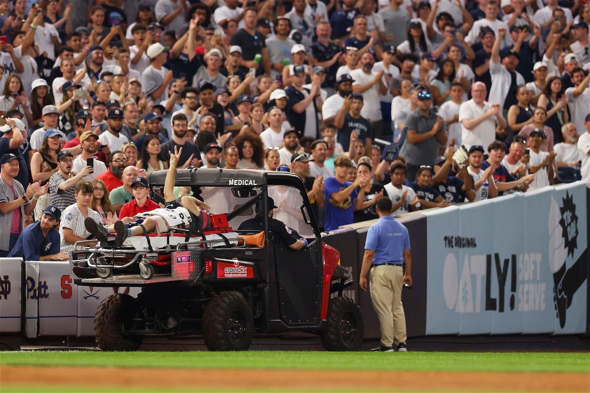 <i>Mike Stobe/Getty Images</i><br/>Pete Stendel waves to the crowd as he is carted off the field after getting hit by an errant throw in the fifth inning during the game between the New York Yankees and the Baltimore Orioles.