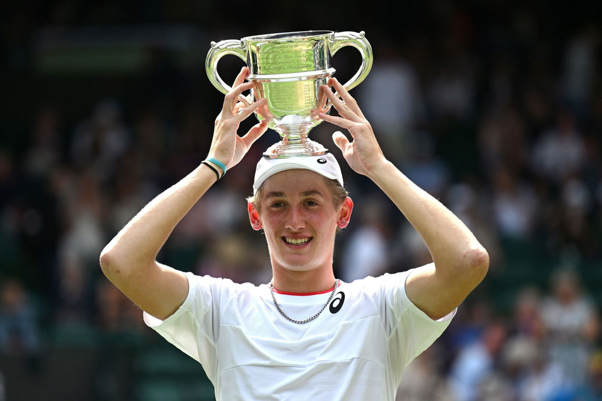 <i>Shaun Botterill/Getty Images</i><br/>Henry Searle holds aloft the boys' singles trophy.