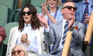 Rachel Weisz (left) and Daniel Craig were at Centre Court in a match that was decided in the fifth set.