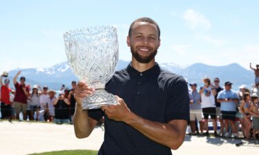 Curry poses with the trophy.