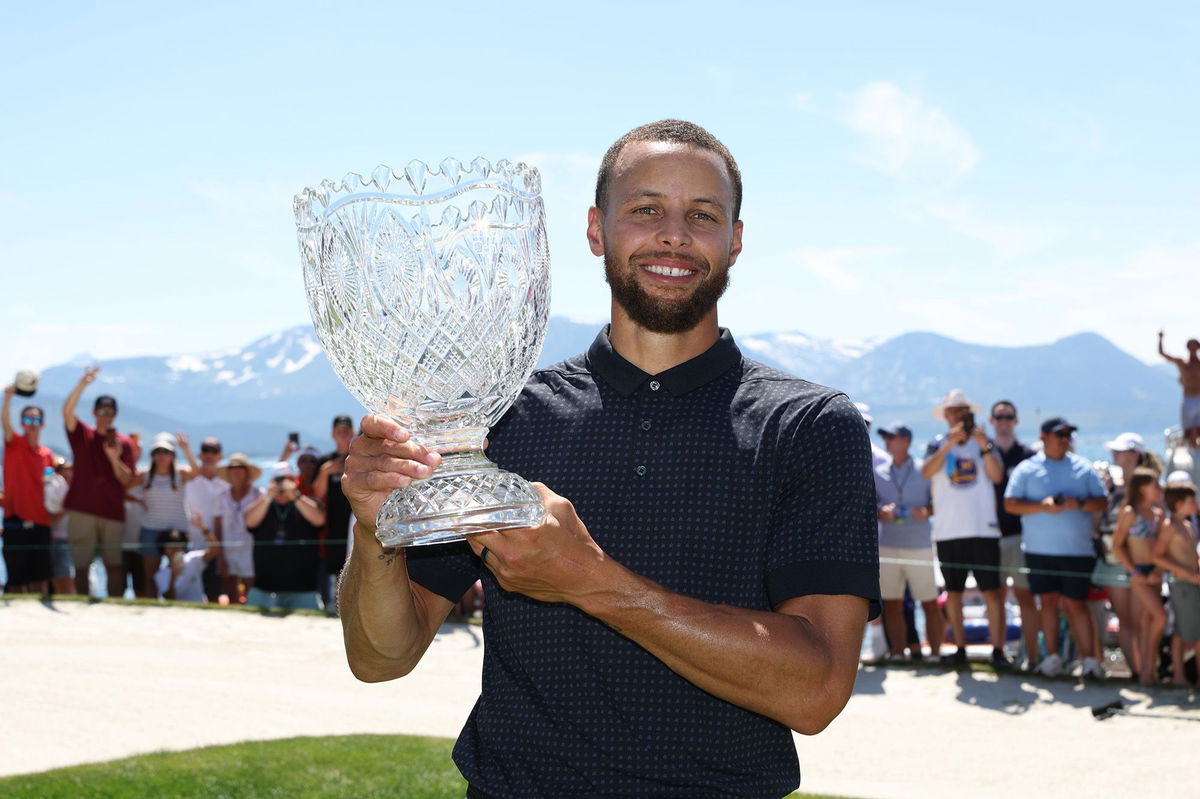 <i>Isaiah Vazquez/Getty Images</i><br/>Curry poses with the trophy.