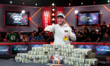 Daniel Weinman displays his championship bracelet and bundles of cash after winning the World Series of Poker Main Event.