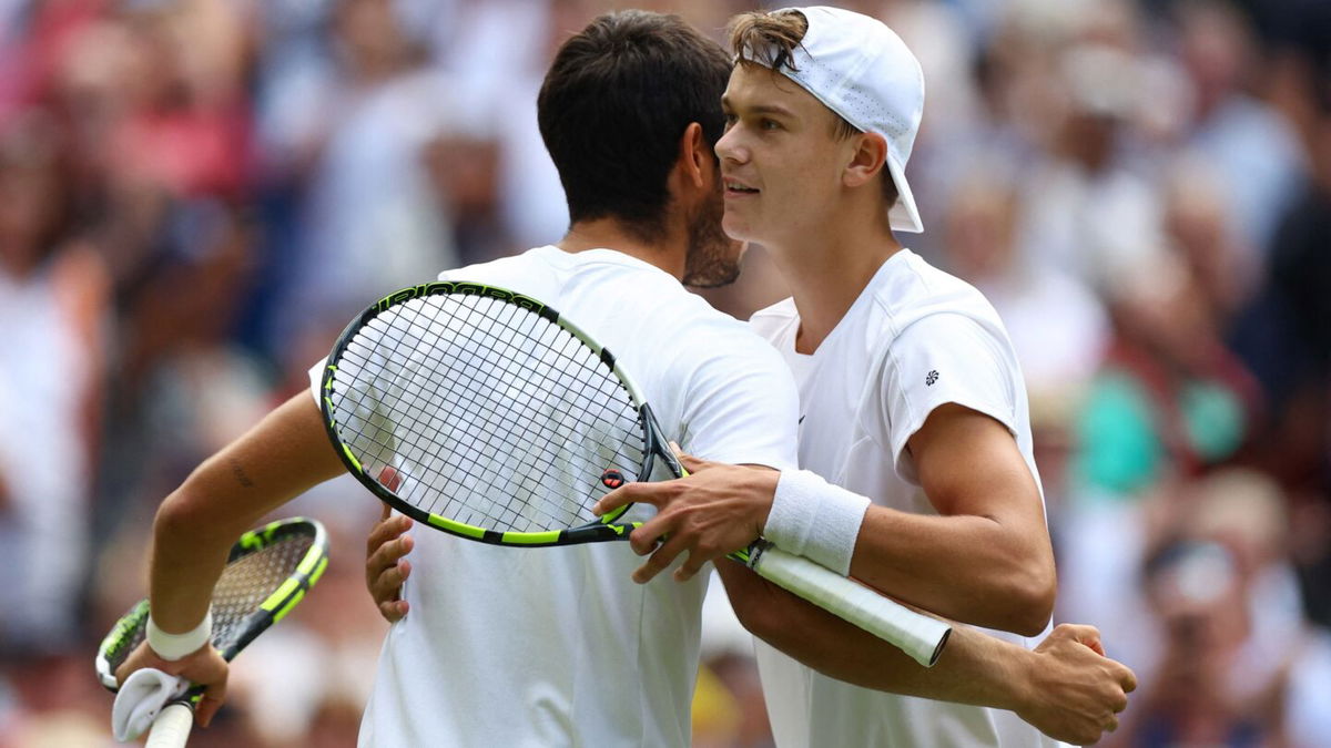 <i>Hannah Mckay/Reuters</i><br/>Carlos Alcaraz and Holger Rune embrace after their Wimbledon quarterfinal.