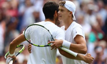 Carlos Alcaraz and Holger Rune embrace after their Wimbledon quarterfinal.