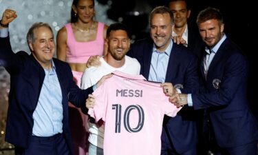 Messi is presented with an Inter Miami jersey alongside club owners Jorge Mas