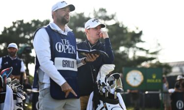 Emiliano Grillo of Argentina looks on alongside caddy James Baker on the 18th hole during Day One of The 151st Open at Royal Liverpool Golf Club on July 20 in Hoylake