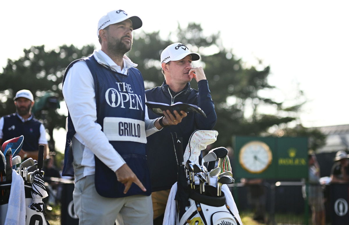 <i>Oisin Keniry/R&A/Getty Images</i><br/>Emiliano Grillo of Argentina looks on alongside caddy James Baker on the 18th hole during Day One of The 151st Open at Royal Liverpool Golf Club on July 20 in Hoylake