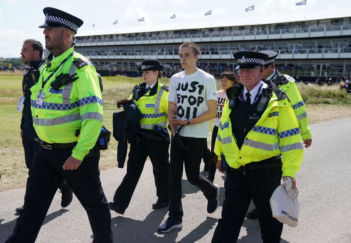 <i>David Davies/PA Images/Getty Images</i><br/>A Just Stop Oil protester is taken away by police during day two of The Open at Royal Liverpool