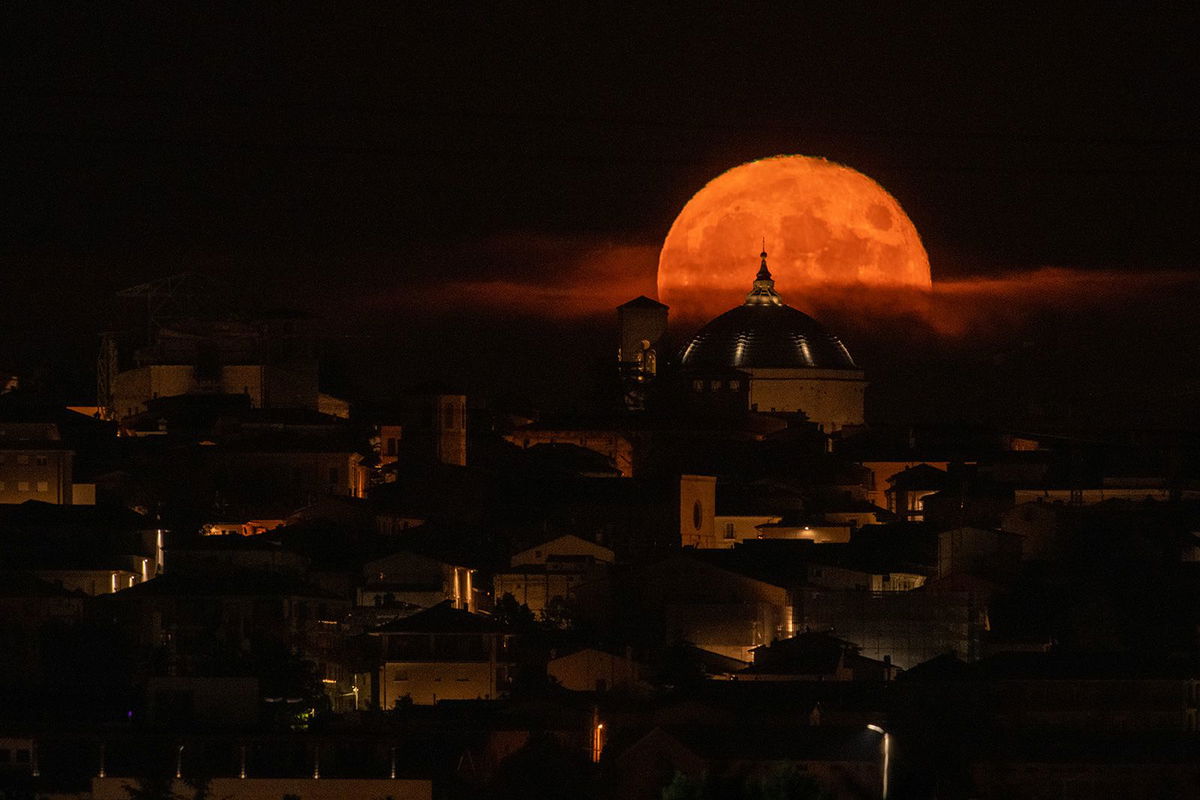 <i>Lorenzo Di Cola/NurPhoto/Getty Images</i><br/>The sturgeon supermoon rises behind the Basilica of San Bernardino in L'Aquila in Italy's Abruzzo region