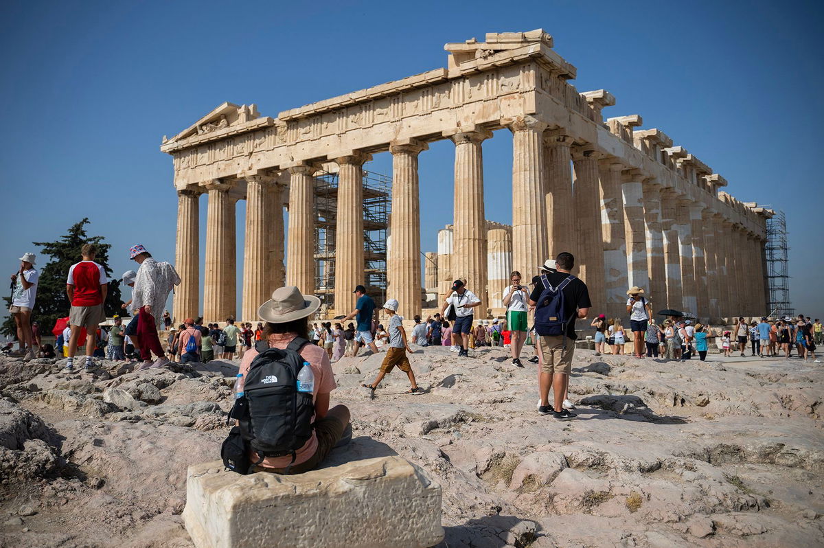 <i>Angelos Tzortzinis/picture alliance/Getty Images</i><br/>Tourists walk around the Acropolis hill in Athens on July 14.