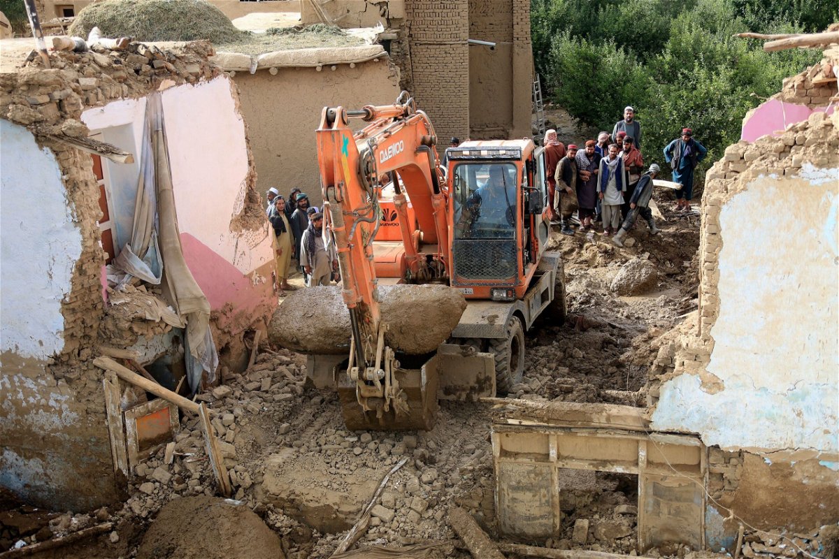 <i>AP</i><br/>An excavator removes mud and rocks from a damaged house after heavy flooding in Maidan Wardak province.
