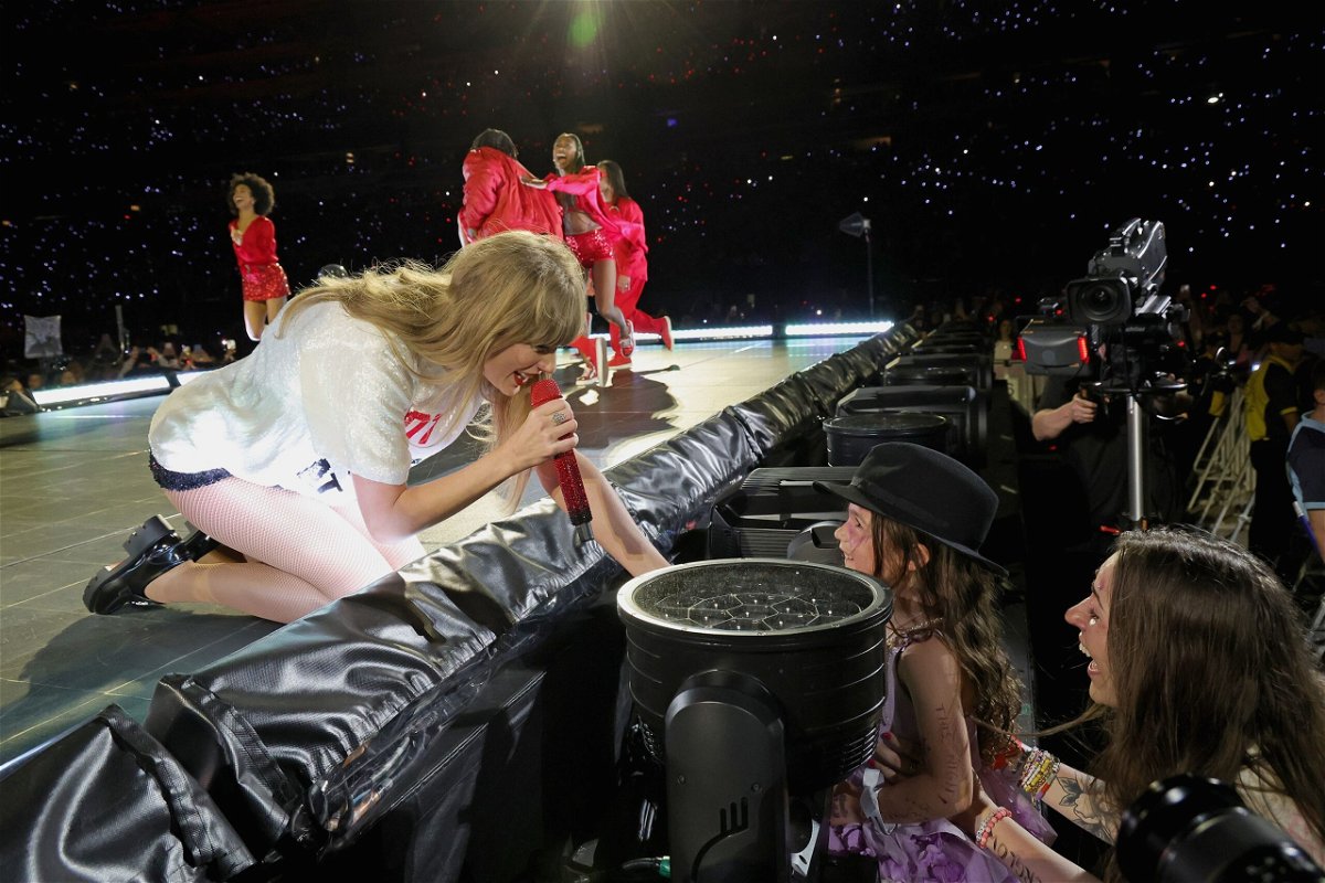 <i>Kevin Mazur/TAS23/Getty Images</i><br/>Taylor Swift gives her hat to a young fan during a New Jersey 