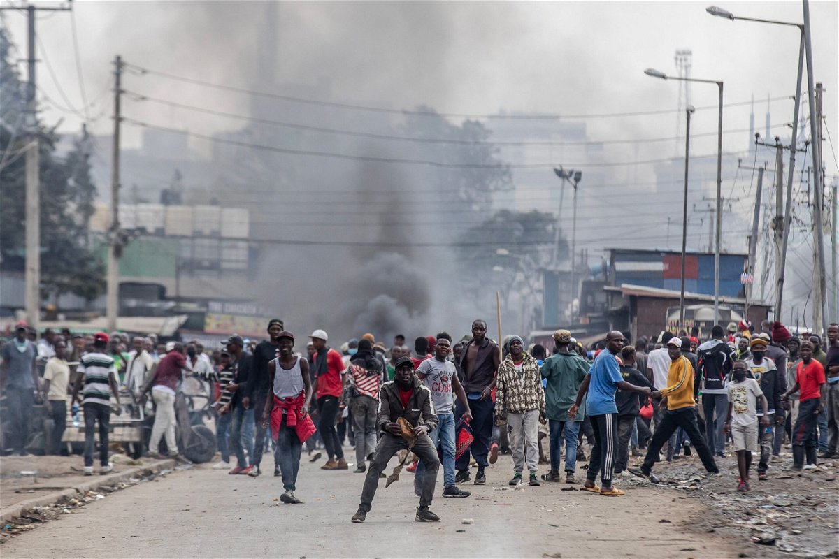 <i>Luis Tato/AFP/Getty Images</i><br/>Kenyan opposition supporters react and throw stones towards Kenya Police officers during demonstrations in Nairobi