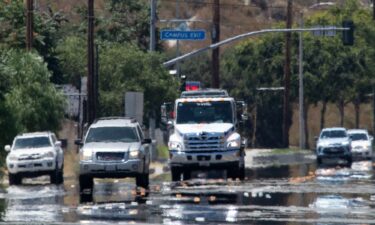 Heat waves and mirage create an impressionistic scene on Sierra Highway during a scorching day on Saturday