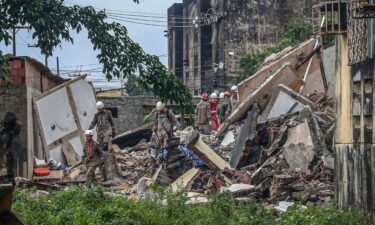 Rescuers search for survivors under the rubble of the collapsed building.