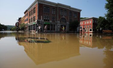 Residents look over the damage after flooding in Montpelier