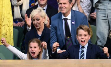 Charlotte and George cheer emphatically as they watch the epic men's finale of the prestigious tennis tournament.