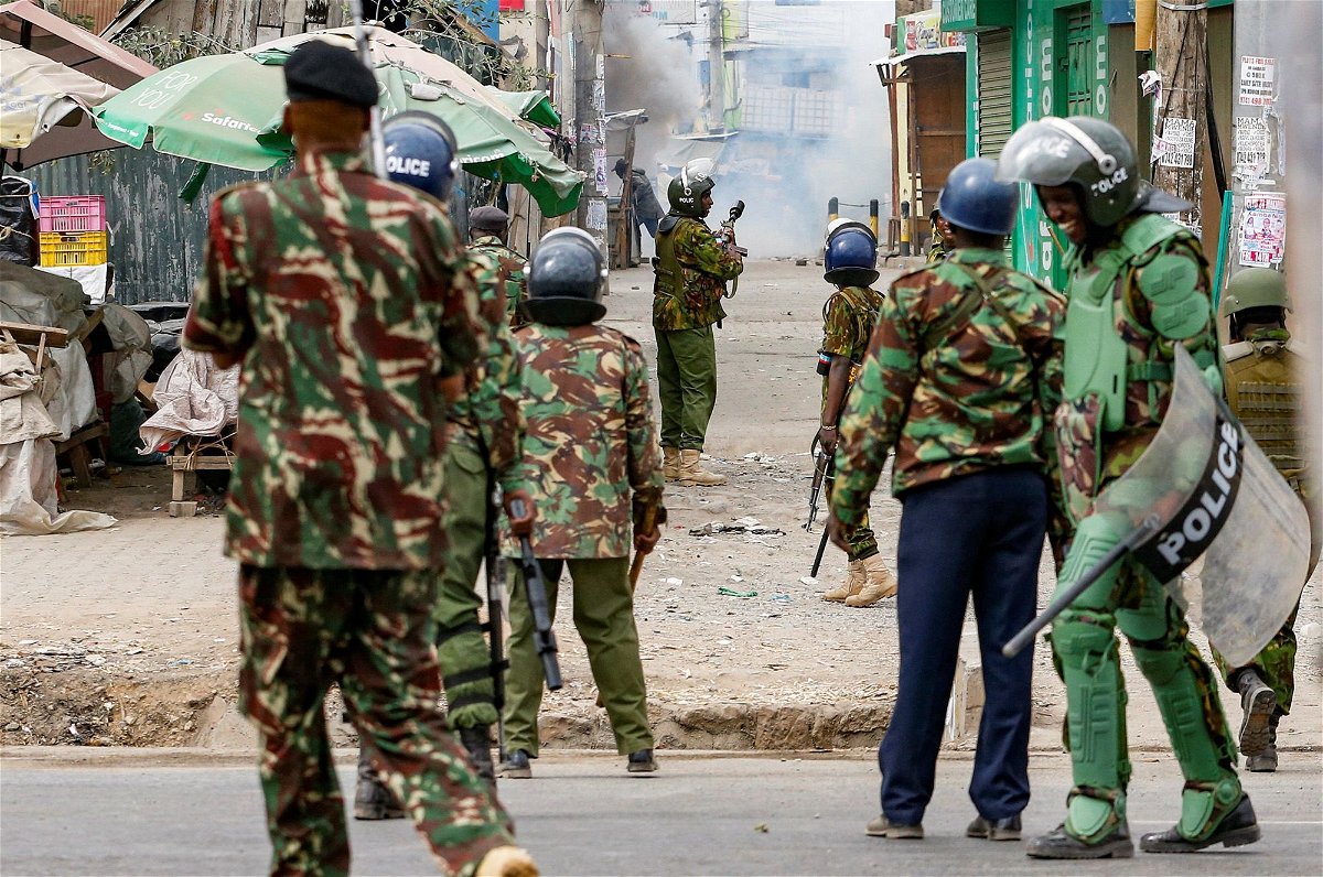<i>Thomas Mukoya/Reuters</i><br/>Riot police officer lobs teargas canisters to disperse supporters of Kenya's opposition leader.