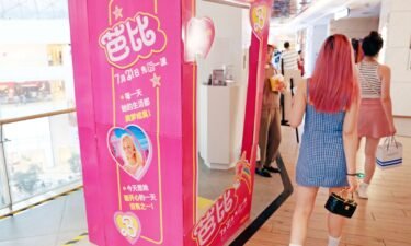 Fans pass a poster of "Barbie" at a cinema in Shanghai