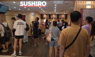 Customers wait to get into Japanese sushi chain Sushiro in Causeway Bay