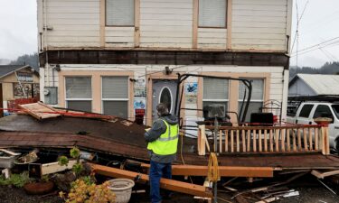 A building inspector red-tags a Rio Dell home -- deeming it too damaged to live in -- after the December 20 quake.