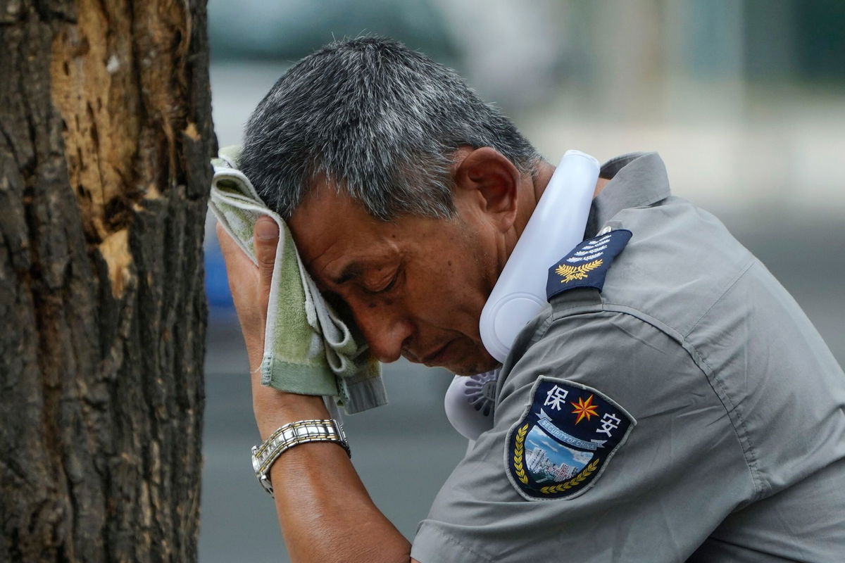 <i>Andy Wong/AP</i><br/>A security guard is pictured here on a hot day in Beijing