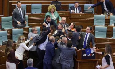 Lawmakers push each other as a brawl breaks out in Kosovo's Parliament.
