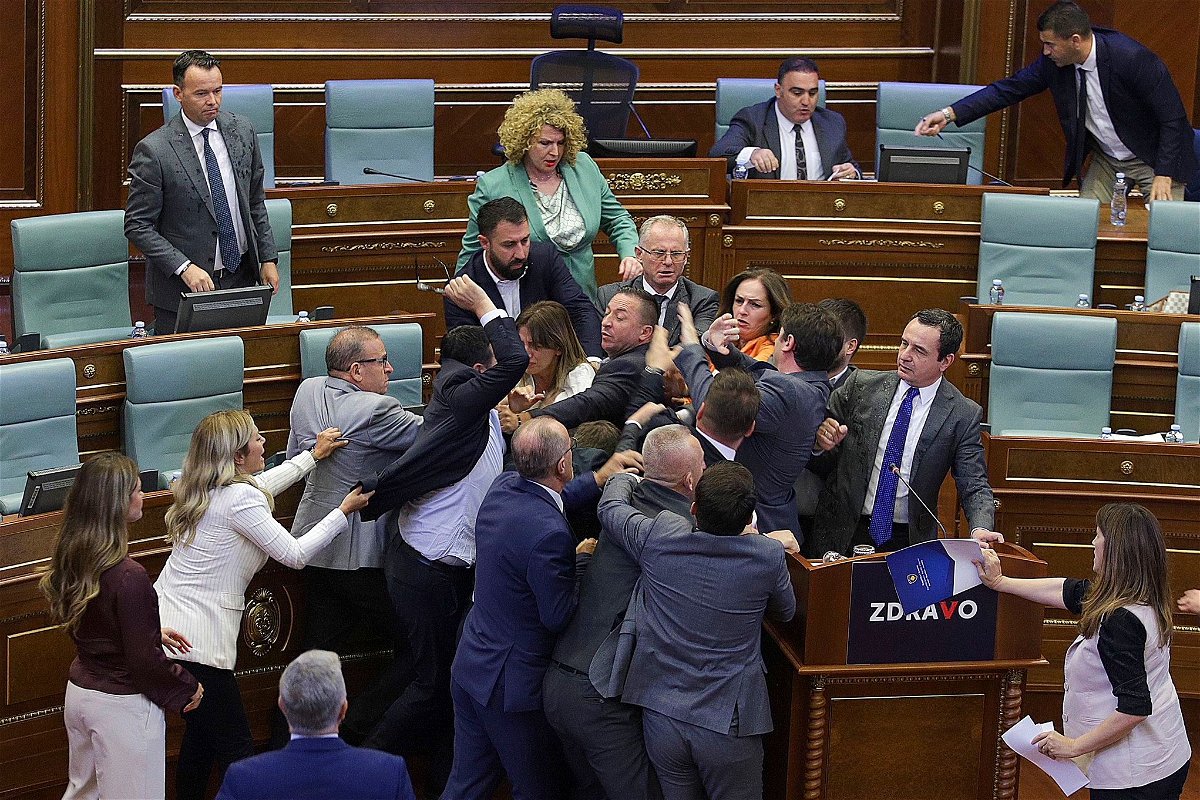 <i>Ridvan Slivova/AP</i><br/>Lawmakers push each other as a brawl breaks out in Kosovo's Parliament.
