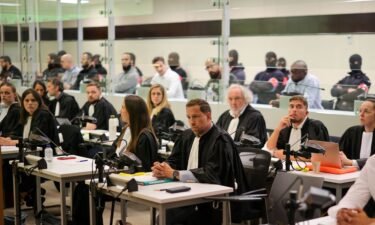 Defendants sit in a specially designed glass box in the courtroom during the start of the Brussels terrorist attack trial verdict being announced in the Palace of Justice building