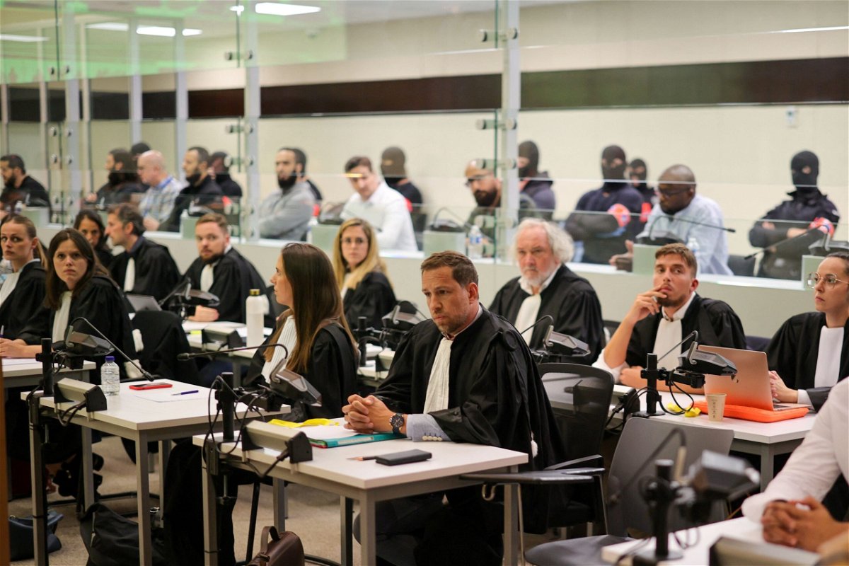 <i>Olivier Matthys/Pool/Reuters</i><br/>Defendants sit in a specially designed glass box in the courtroom during the start of the Brussels terrorist attack trial verdict being announced in the Palace of Justice building