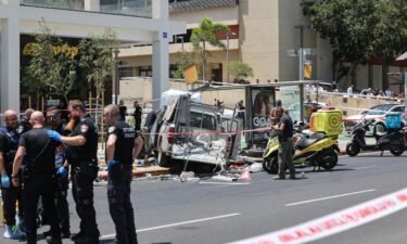 Members of Israeli security and emergency personnel work at the site of the car ramming attack in Tel Aviv on July 4.