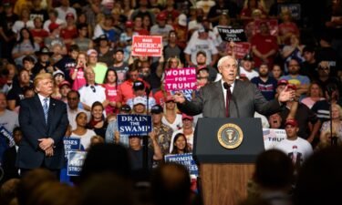 West Virginia Governor Jim Justice announces in August 2017 that he is switching parties to become a Republican as then-President Donald Trump listens at a campaign rally in Huntington