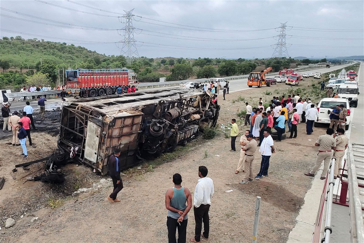 <i>Gajanan Mehetre/AFP/Getty Images</i><br/>People gather around the wreckage of a bus that caught fire along the Samruddhi Mahamarg expressway near Sindkhed Raja in the Buldhana district of Maharashtra state