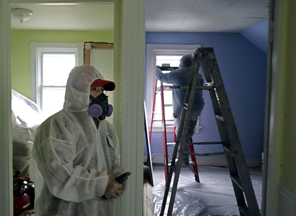 <i>Chitose Suzuki/AP/File</i><br/>Contractors clean up lead paint at a contaminated building in Providence