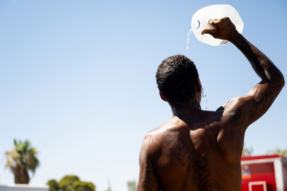 <i>Brandon Bell/Getty Images</i><br/>A person cools off amid searing heat on July 16 in Phoenix