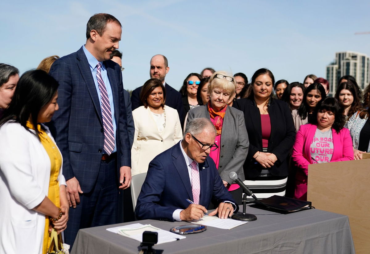 <i>Lindsey Wasson/AP</i><br/>Washington Gov. Jay Inslee prepares to sign House Bill 1340