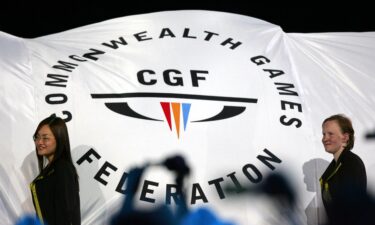 The Commonwealth Games Federation flag is carried into the arena during the Games opening ceremony in Melbourne