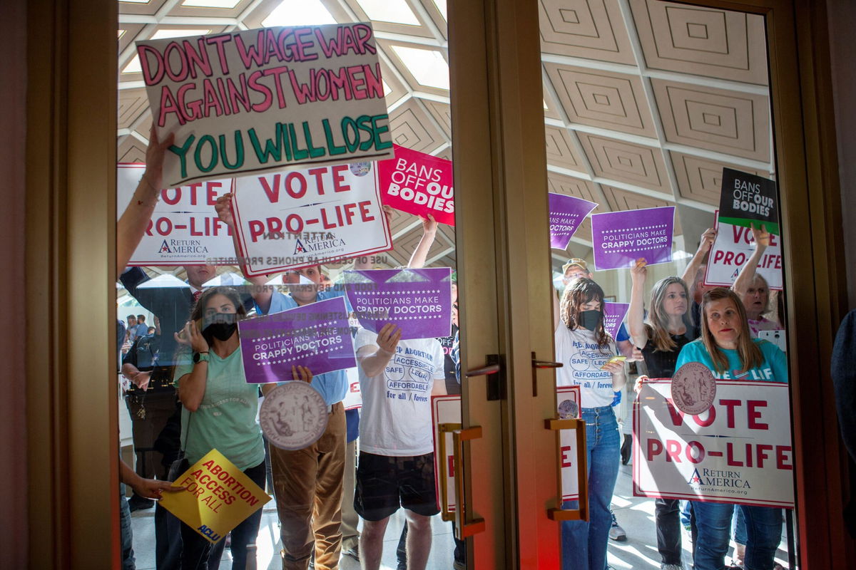 <i>Erin Siegal McIntyre/Reuters</i><br/>Demonstrators hold signs as North Carolina Republican lawmakers hold a vote to override Democratic Governor Roy Cooper's veto of a bill that would ban most abortions in the state after 12 weeks