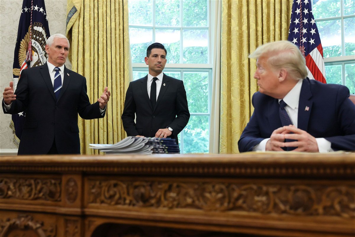 <i>Jonathan Ernst/Reuters</i><br/>Then-US President Donald Trump listens to Vice President Mike Pence and acting Secretary of Homeland Security Chad Wolf
