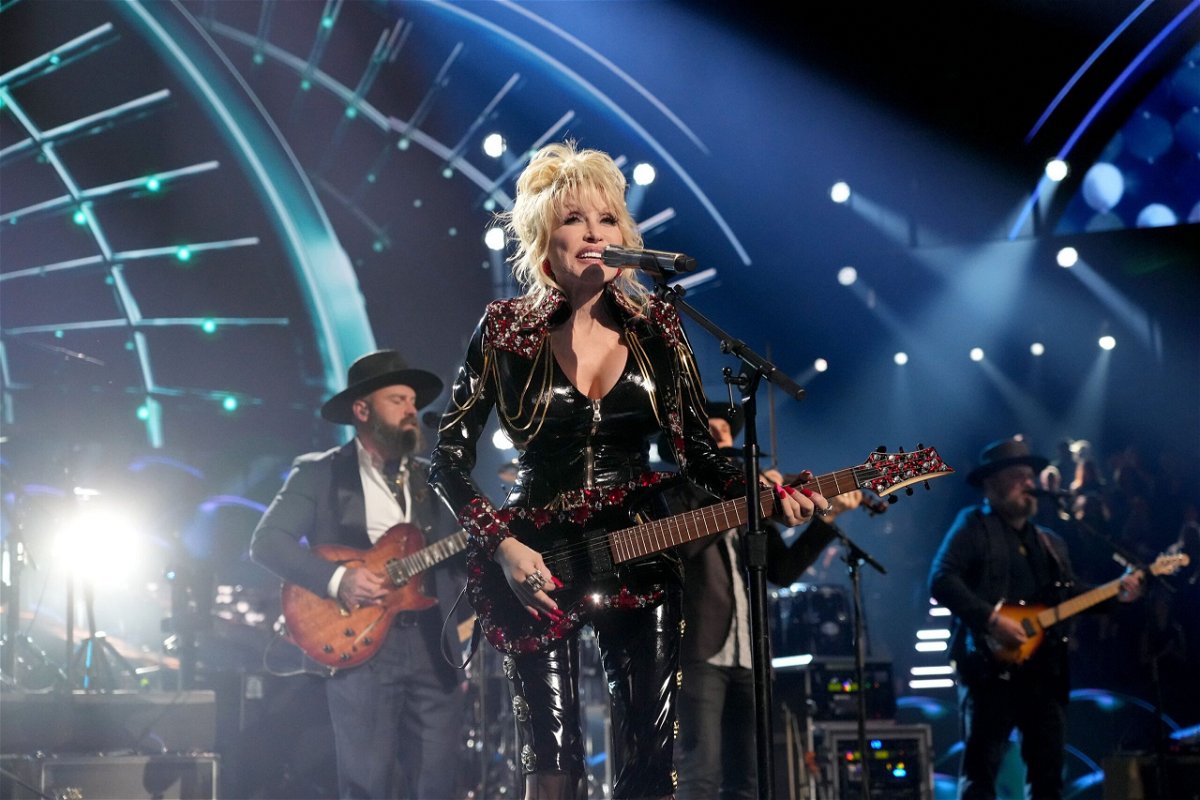 <i>Kevin Mazur/Getty Images</i><br/>Dolly Parton performs in Los Angeles at the Rock and Roll Hall of Fame induction ceremony in 2022.